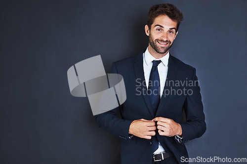 Image of Portrait, smile and mockup with a business man in studio on a blue background for contemporary corporate style. Success, professional and a confident male employee in a suit for executive fashion