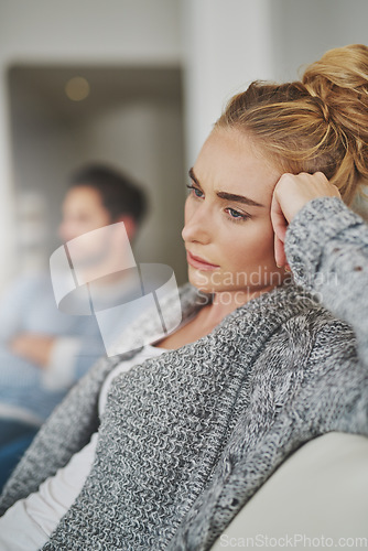 Image of Sad, depression and woman in conflict with her boyfriend in the living room of their apartment. Upset, disappointed and moody female person in argument, fight or breakup with partner at their home.