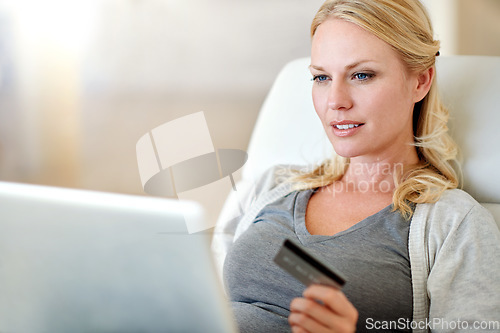 Image of Woman, laptop and credit card for ecommerce, payment or electronic purchase in living room at home. Female person or shopper on computer for online shopping, bank app or internet banking at the house