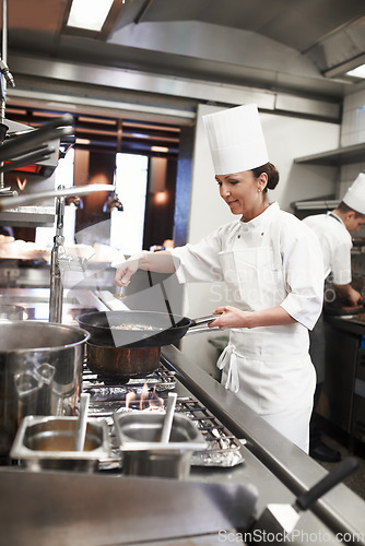 Image of Chef, woman and frying pan with sauce in restaurant kitchen, catering service and prepare food for fine dining. Professional, cooking and female saucier or person with meat meal for hospitality.