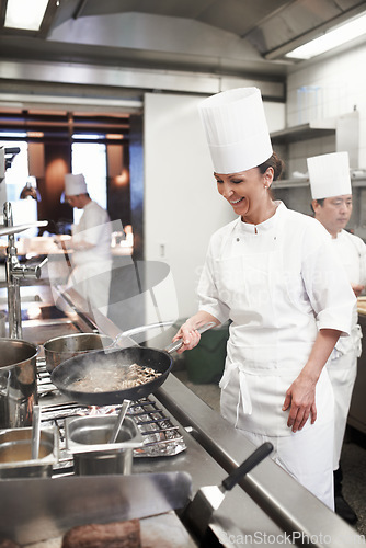 Image of Chef, woman and frying in restaurant kitchen, catering service and prepare food for fine dining. Professional, cooking and female person saute meat with cook pan making meal nutrition for hospitality
