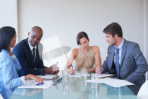 Image of Discussion, writing and business people planning in a meeting in office brainstorming for corporate project. Communication, teamwork and professional employees working in collaboration in workplace.