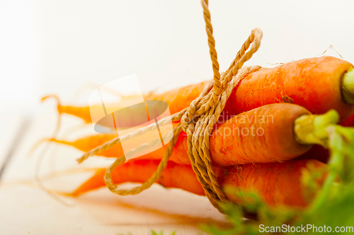 Image of baby carrots bunch tied with rope