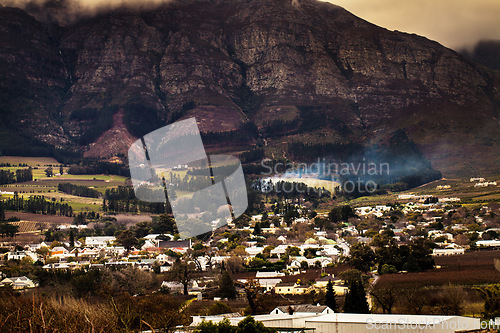 Image of Urban development, suburb or cityscape by mountain, buildings and housing in Cape Town. Outdoor, landscape and mountains with houses, night and hill for real estate, property or holiday by skyline