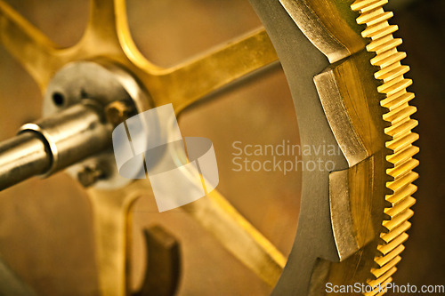 Image of The mechanics of time. Clock gear, gold and vintage wheel cog of golden machinery and gears. Metal, closeup and steel with machine detail and maintenance with retro brass parts and wheels.