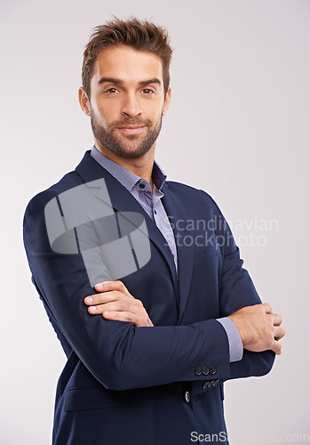 Image of Portrait of business man, arms crossed with confidence in a suit isolated on studio background. Professional mindset, career success and businessman with corporate male employee and leadership