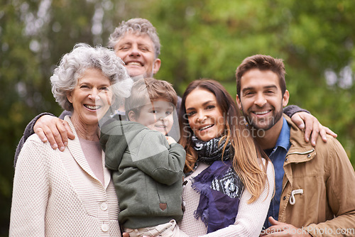 Image of Happy and big family, child and portrait of people with kid in a park on outdoor vacation, holiday and faces together. Grandparents, happiness and parents bonding for love, care and in nature