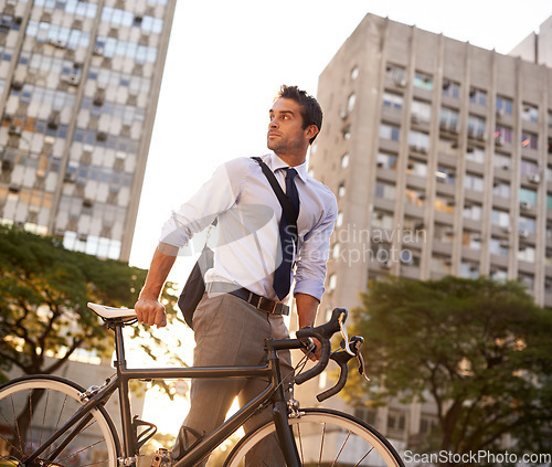 Image of Cycling, commute and business man in city for morning, carbon neutral and transportation. Sustainable, professional and travel with male employee walking with bike in urban town for journey and trip