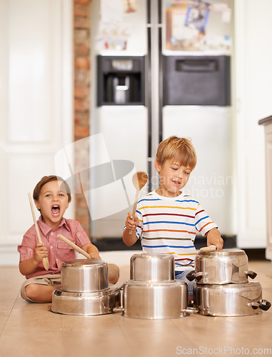 Image of Rock, pots and drums with children in kitchen for imagination, fantasy and games. Bonding, siblings and happy with kids and kitchenware on floor of family home for music, noise and happiness