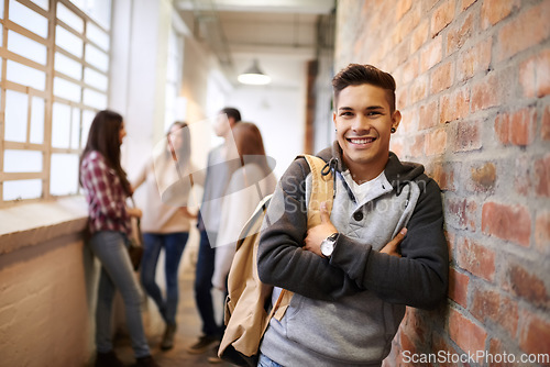 Image of Education, arms crossed and portrait of man in school hallway for studying, college and scholarship. Future, happy and knowledge with student leaning on brick wall for university, academy and campus