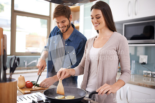 Image of Happy couple, food and cooking together in the kitchen on pan with healthy organic nutrition or diet for dinner at home. Man helping woman with smile in happiness making meal with vegetables on stove