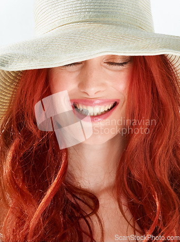 Image of Happy woman, face and ginger or red hair with straw hat in studio, isolated white background and beautiful style. Female model with happiness and closeup of cool summer accessory, fashion and beauty