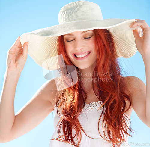 Image of Woman, face and smile with straw hat on blue sky with style, confidence and fun outdoor vacation. Happy female person in sunshine with summer fashion, head accessory and freedom to relax on holiday