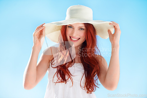 Image of Happy, portrait of young woman with hat in sun and in blue sky background. Mockup, fashion during summer and cheerful female person with ginger or red hair on vacation or holiday outdoor in sunshine