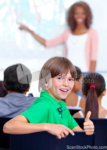 Image of Thumbs up, teaching and child portrait for happy learning, support and thank you with education success, school or geography. Like, yes and achievement hand or emoji of boy kid with map in classroom
