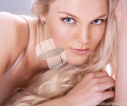 Image of Sensual, makeup and portrait of a female model with a self care, natural and luxury routine. Cosmetic, beauty and closeup face of beautiful, young and attractive woman with a elegant seductive pose.