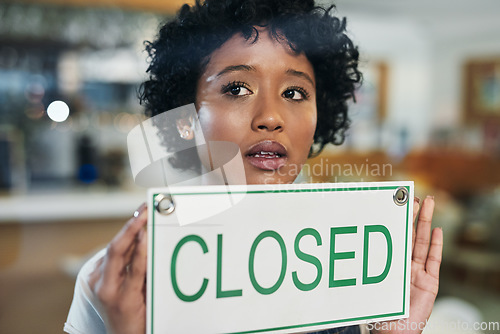 Image of Sad woman, face and closed sign on window at cafe in small business, bankruptcy or fail. Female person or waitress holding billboard in store debt, financial crisis or out of service and closing shop