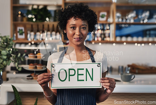 Image of Woman, open sign and portrait in cafe of small business owner or waitress for morning or ready to serve. Female person or restaurant server holding board for coffee shop, store or cafeteria opening