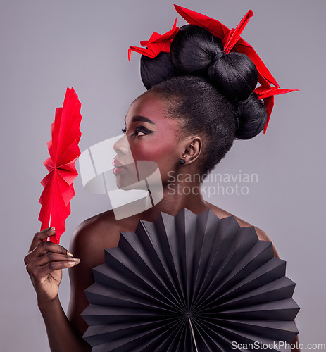 Image of Culture, makeup and creative with black woman in studio for origami, art and beauty. Traditional, cosmetics and paper design with female model and fans on grey background for asian, retro or color