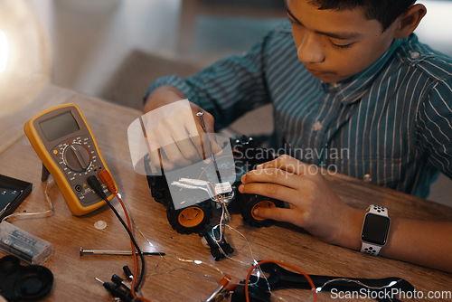 Image of Education, car robot and top view of child with homework, homeschool and science, learning and tech project. Robotics, building and boy kid with electrical knowledge, engineering or studying in house