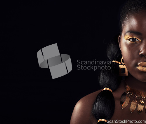 Image of Half, portrait and black woman in studio with gold, luxury and makeup on black background. Glitter, face and African female model with wealth, glow and jewellery, elegance and posing royal aesthetic