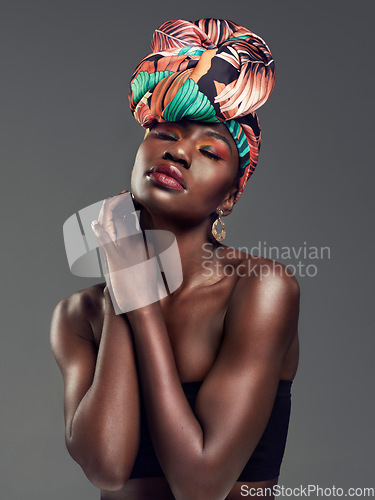Image of Fashion, beauty and face of black woman in studio on gray background for glamour, cosmetics and makeup. Jewellery, designer and female person in exotic jewelry, African style and head scarf in studio