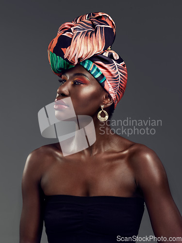 Image of African fashion, makeup and face of black woman in studio on gray background with luxury, cosmetics and beauty. Glamour, culture and female person glow in exotic jewelry, traditional style and scarf