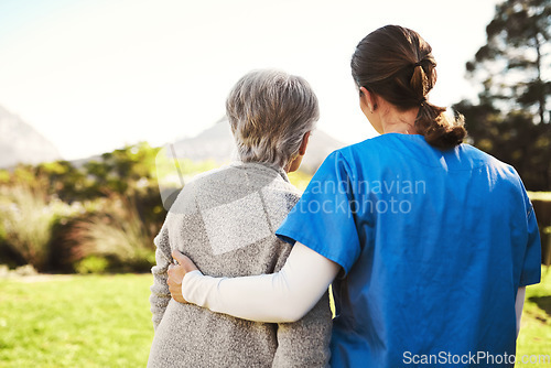 Image of Senior woman, nurse and hug in healthcare, life insurance or support together in nature. back view of mature female with caregiver in elderly care, medical aid or garden walk at nursing home outdoors