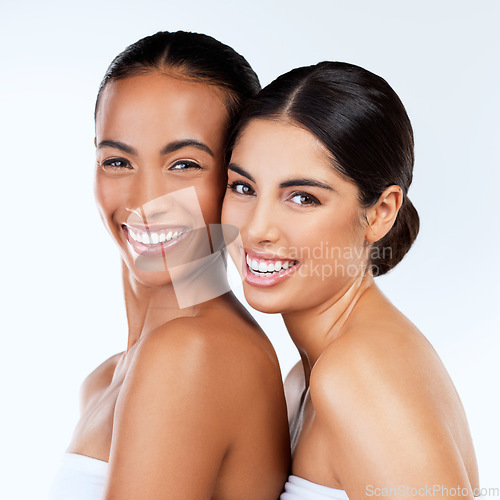 Image of Women friends, studio portrait and cosmetics with smile, beauty and wellness by white background. Lesbian woman, skincare and happy together with excited face, natural glow and isolated for makeup