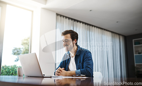 Image of Business man, video call and laptop in home office for listening, audio and communication at desk. Young businessman, computer and earphones for webinar, online consultation or remote work with smile