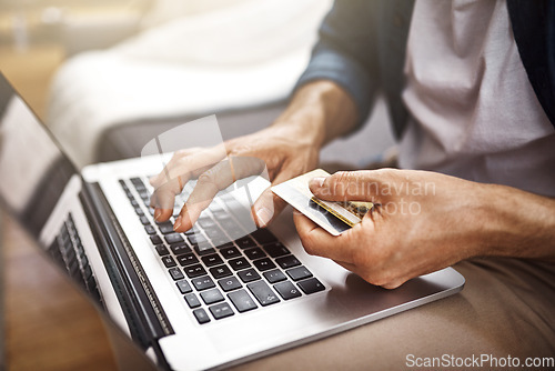 Image of Hands, laptop and credit card for man, typing and online shopping with cybersecurity, tech or payment. Guy, computer and fintech on internet store for discount, sale or deal with password for banking