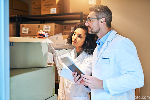 Image of Tablet, box and pharmacy with people and inventory for shipping, cargo or medical supplies. Digital, checklist and delivery with man and woman in storage room for medicine, healthcare and drugs store