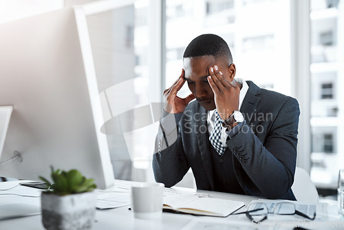 Image of Professional black man, headache and stress in workplace with burnout, depression and brain fog in office. Male person with pain at desk, migraine and tired, overworked and business crisis anxiety