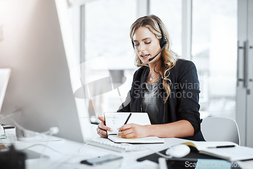 Image of Woman with headset, call center and writing in notebook, notes and phone call with communication and CRM. Customer service, telemarketing and tech support with female consultant at desk with agenda