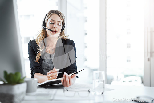 Image of Secretary, receptionist and woman writing notes in the office planning company schedule. Call center, telemarketing and female customer support agent working on crm strategy with desktop in workplace