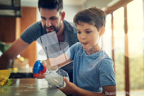 Image of Family, father and son cleaning the kitchen counter, development and growth at home. Parent, male child and dad with kid, support and teaching with chores, helping and learning with responsibility