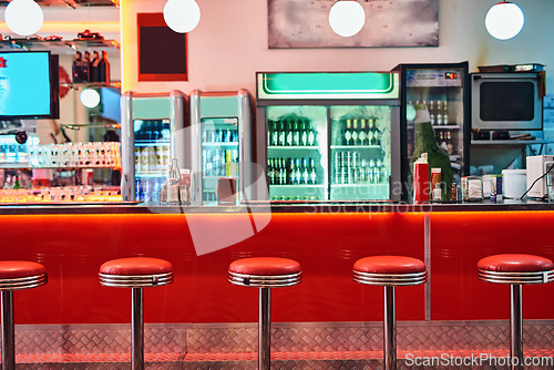Image of Retro, vintage and stools with interior in a diner, restaurant or cafeteria with funky decor. Trendy, old school and chairs by a counter or bar in groovy, vibrant and stylish old fashioned empty cafe