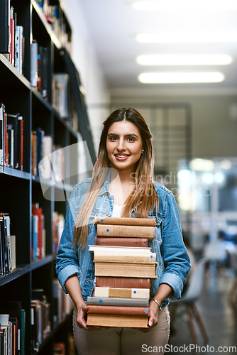 Image of Woman, college student with stack of books in library and research with studying and learn on university campus. Female person smile in portrait, education and scholarship with reading material