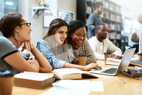 Image of Women, students in library with laptop and studying for exam or research for project with education. Young female people in study group, search internet on pc and learning on university campus