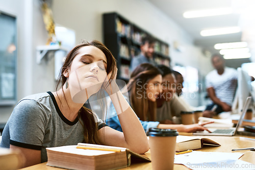 Image of Woman, tired and books for studying at library, college or campus with stress, anxiety or burnout. University student, girl and headache with education, study and fatigue on face at school with sleep