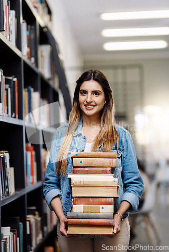 Image of Woman in portrait, college student with stack of books in library and research, studying and learning on university campus. Female person with smile, education and scholarship with reading material