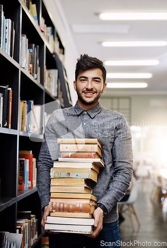 Image of Man in portrait, college student with stack of books in library and research, studying and learning on university campus. Male person with smile, education and scholarship with reading material