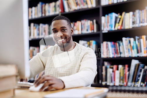 Image of Portrait, smile and black man in a library, computer and search website for information, research and knowledge. Face, male person and student with technology, internet and university for education