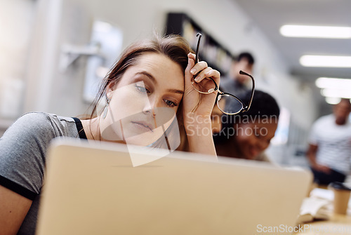 Image of Woman, frustrated and laptop for study at library, college or campus for tired face, anxiety or burnout. University student, girl and computer for education, studying or fatigue at school with stress