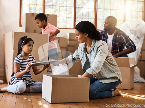 Image of Moving, family and packing boxes in home living room together with children, mom and dad. Property, real estate investment and house move with couple, kids helping box and cardboard unpacking