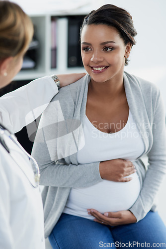 Image of Pregnant woman, smile and doctor in a hospital at baby check up with happiness. Stomach, pregnancy and healthcare with a professional in clinic with a African female patient in wellness consultation