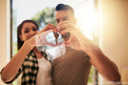 Image of Heart, hands and couple with a keys, home and happiness for growth, development and real estate. Partners, man and woman with new property, symbol for love and goals with achievement and apartment