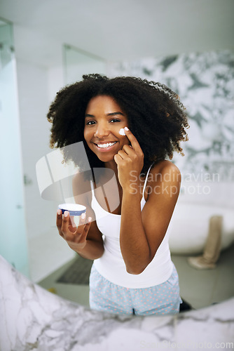 Image of Skincare, smile and portrait of black woman in bathroom mirror with cream, dermatology and morning routine. Health, wellness and luxury skin care at home, happy girl in reflection with lotion on face