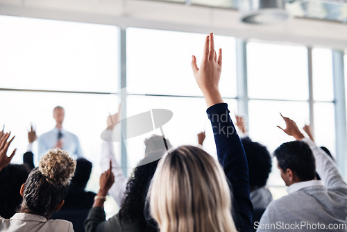 Image of Conference, convention and business people with hands for a question, vote or volunteering. Corporate event, meeting and hand raised in a training seminar for questions, voting or audience opinion