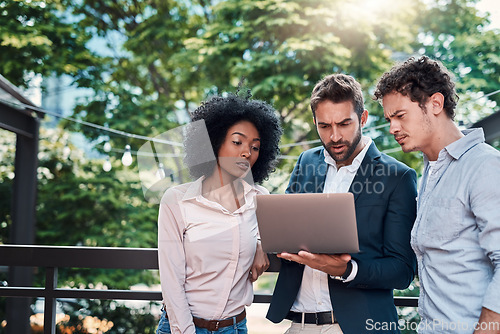 Image of Collaboration, laptop and business people together outdoor, working and brainstorming. Teamwork, computer and group of employees, men and black woman planning, meeting and serious cooperation in city